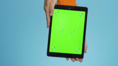 vertical Close up shoty using a tablet computer with green mockup screen. High quality FullHD footage