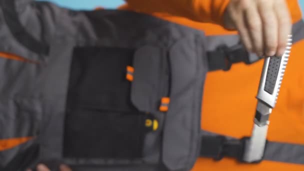 Vertical Video Repairman Orange Shirt Overalls Handing Utility Knife High — Stock Video