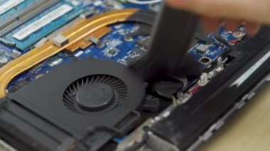close up shot cleaning disassembled laptop brushing cooling system during maintenance. Repair laptop device concept. High quality 4k footage