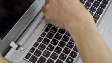 removing keyboard from laptop damaged laptop repair disassembly process. High quality 4k footage