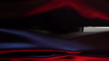  vertical video of crazy man with pig mask shaking head back and forthin font of curtains red room . High quality 4k footage