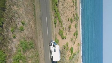 A truck is driving up a winding road through the Beklemeto in Bulgaria during the springtime. The green background is beautiful and the truck looks like its moving quickly. High quality FullHD