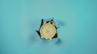 second count with our vintage-inspired yellow alarm clock, showcased against a stunning blue backdrop. This stock photo is perfect for businesses or individuals looking to convey the concept of time
