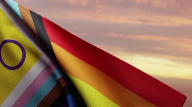 Cinsel içerikli İlerleme Gurur Bayrağı çarpıcı bir günbatımına karşı canlı bir şekilde dalgalanarak LGBT topluluğu içindeki birlik ve beraberliği sembolize ediyor. Çeşitliliği ve gururu kutlamak için mükemmel.