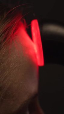 Bu dikey videoda LED ışık terapisi kullanan bir kadının modern bir banyoda cilt bakımını yaptığı son moda bir güzellik gösterisi keşfedin. Dijital pazarlama ve refah içeriği için mükemmel