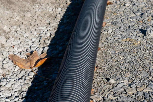 Plastic Corrugated Black Pipe Lying Rocky Surface View — Stock Photo, Image