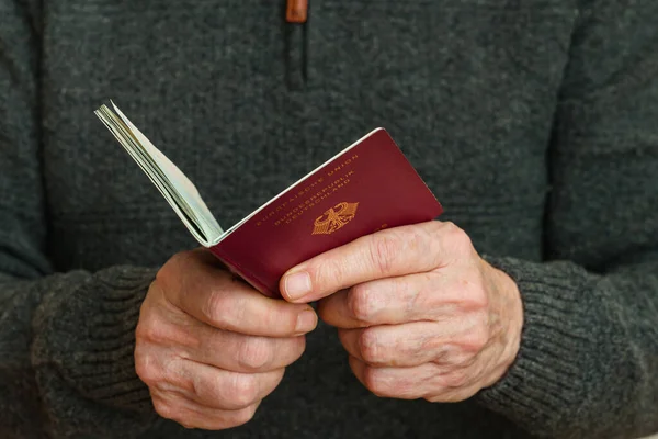 Open german biometric passport in human hands. Close-up.