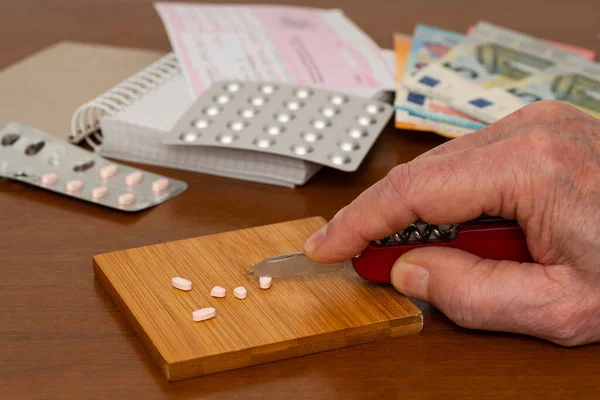 Human Hand Divides Medical Pills Knife Wooden Table Money Banknotes — Stock Photo, Image