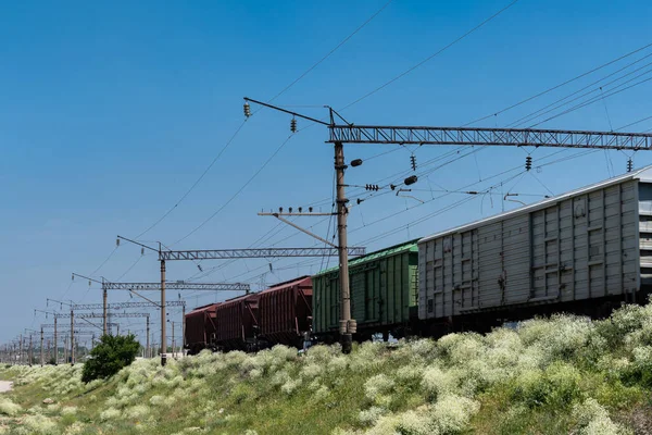 Stock image View of the railroad track with rolling cars falling. Clear blue sky.