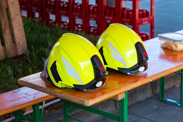 Yellow Helmets Rescue Service Lying Wooden Bench Close — Stock Photo, Image
