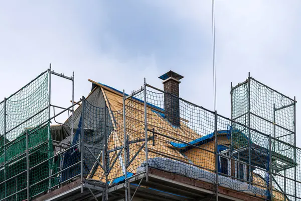 Roof of a private building covered with scaffolding for roof repair.
