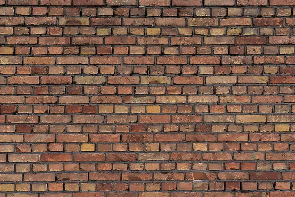 stock image A close-up of a red brick wall with mortar joints. Horizontal texture.