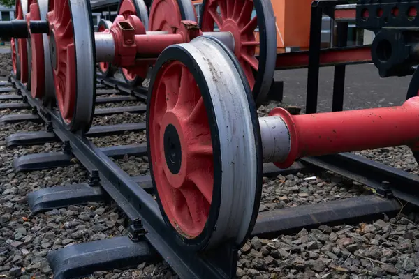 stock image Red train wheels on a set of tracks, close-up view.