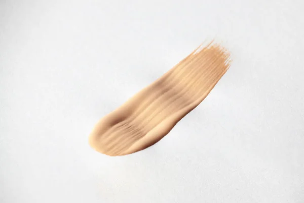 Make up smear foundation smudge texture. Liquid foundation swatch close up.
