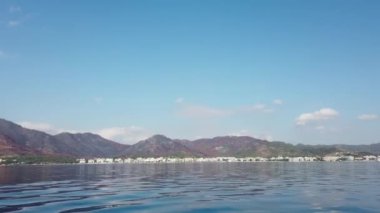 Landscape view of Marmaris city in Turkey. Seaside of resort town with white sand beach. City coastline. Marmaris, Turkey - September 8, 2022.