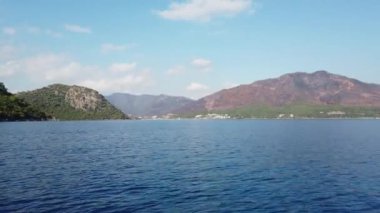 Landscape view of Marmaris city in Turkey. Seaside of resort town with white sand beach. City coastline. Marmaris, Turkey - September 8, 2022.