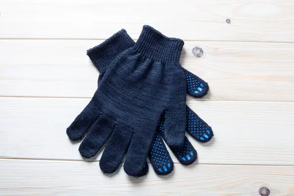 pair of black working gloves with rubber dots