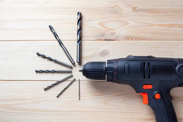Close up Electric drill, Drill set, Screwdriver set on wooden table background. Electric cordless hand drill on wooden. maintenance home concept.