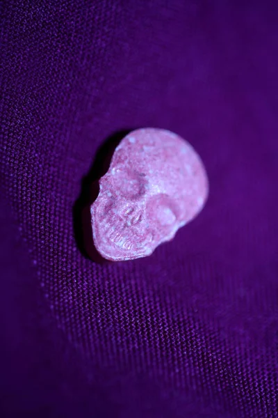 Pink skull ecstasy pill close up background high quality prints purple army dope narcotics substance high dose psychedelic way of life