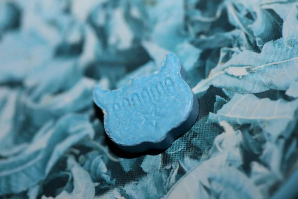 Blue ecstasy owl pill with mdma very strong dope close up background party times psychedelic season high quality big size prints