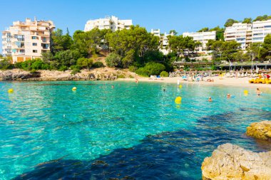Ses Illetes, Majorca, Balearic islands, Spain. July 20th, 2022 - Terrace of the restaurant of the Balneario Illetas spa next to the beach, with umbrellas and loungers and pedal boats
