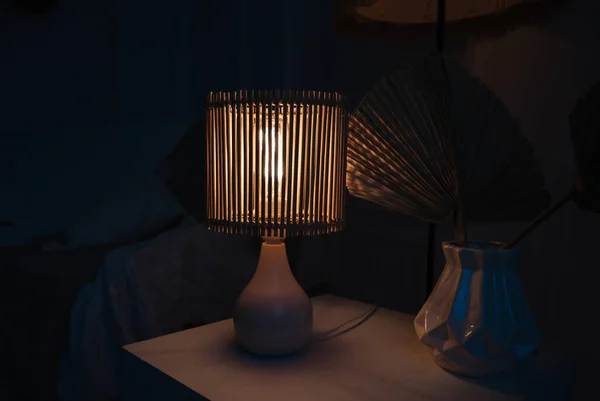 a wooden lamp shines on the table
