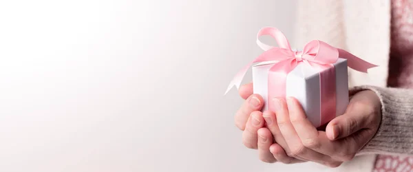 Woman Holding Small White Gift Box Pink Ribbon Soft Grey — Stock Photo, Image