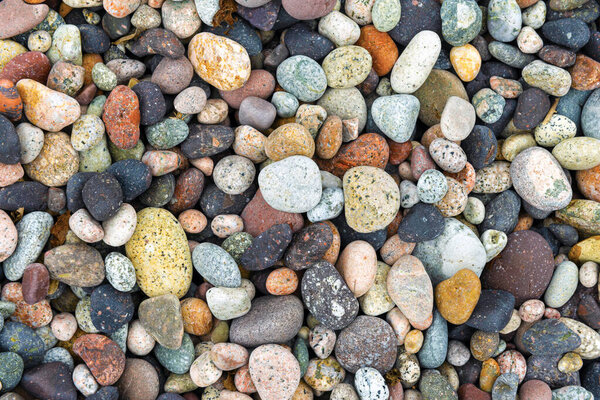 colorful pebbles on a beach in Porto, Corsica, France