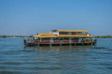 Houseboat in Kerala backwater sailing through the canals in Alleppey India clipart