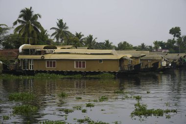 Houseboat in Kerala backwater sailing through the canals in Alappuzha India clipart