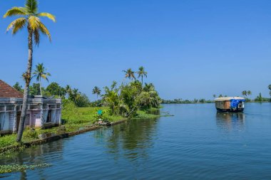 Houseboat in Kerala backwater sailing through the canals in Alleppey India clipart