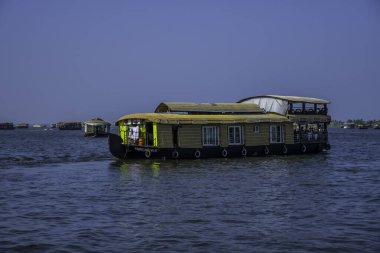 Houseboat in Kerala backwater sailing through the canals in Alleppey India clipart