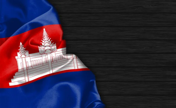 在黑色木制背景的顶部悬挂柬埔寨国旗 — 图库照片