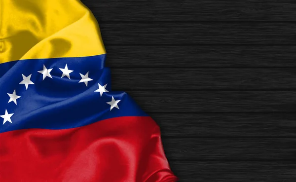 委内瑞拉国旗在黑色木制背景的顶部的遮掩 — 图库照片