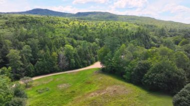 Flying up to Hersey Mountain in summer from town center of New Hampton, New Hampshire NH, USA. Hersey Mountain is between town of New Hampton and Sanbornton. 