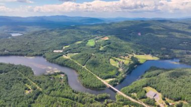 Pemigewasset River and New Hampton historic center aerial view from Hersey Mountain in summer, with White Mountain at the background, New Hampton, New Hampshire NH, USA. 