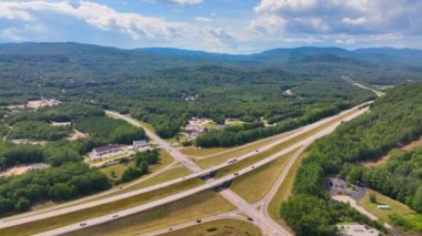 Interstate Highway I-93 at Exit 28 in summer with White Mountain National Forest at the background in town of Campton, New Hampshire NH, USA. 