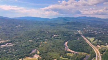 Aerial view of Campton Mountain, Pemigewasset River and Interstate Highway I-93 in summer with White Mountain National Forest at the background in town of Campton, New Hampshire NH, USA. 