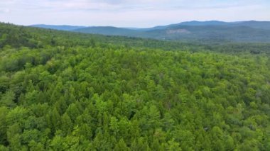 Flying over the Campton Mountain in summer with White Mountain National Forest at the background in town of Campton, New Hampshire NH, USA. 