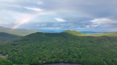 Aerial view of Rainbow over Stinson Lake in White Mountain National Forest in summer in town of Rumney, Grafton County, New Hampshire NH, USA. 