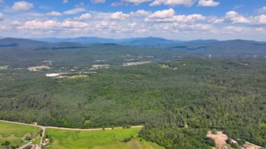 Aerial view the Plymouth rural landscape near Tenney Mountain in summer with White Mountain National Forest at the background in town of Plymouth, New Hampshire NH, USA. 