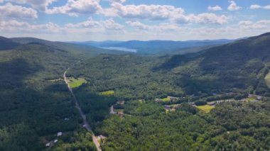 Tenney Mountain Ski Resort with Plymouth rural landscape in summer with White Mountain National Forest at the background in town of Plymouth, New Hampshire NH, USA. 