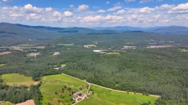 Tenney Mountain Ski Resort with Plymouth rural landscape in summer with White Mountain National Forest at the background in town of Plymouth, New Hampshire NH, USA. 