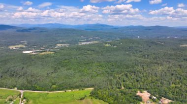 Aerial view the Plymouth rural landscape near Tenney Mountain in summer with White Mountain National Forest at the background in town of Plymouth, New Hampshire NH, USA. 