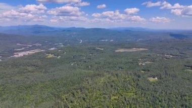 Tenney Mountain Ski Resort with Plymouth rural landscape in summer with White Mountain National Forest at the background in town of Plymouth, New Hampshire NH, USA. 