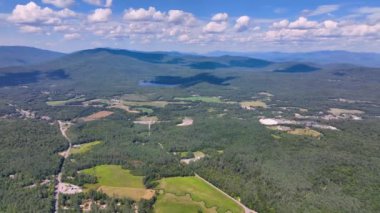 Tenney Mountain Ski Resort with Plymouth rural landscape in summer with White Mountain National Forest at the background in town of Plymouth, New Hampshire NH, USA. 