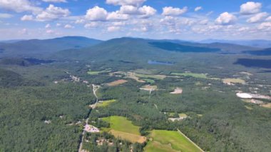 Aerial view the Plymouth rural landscape near Tenney Mountain in summer with White Mountain National Forest at the background in town of Plymouth, New Hampshire NH, USA. 