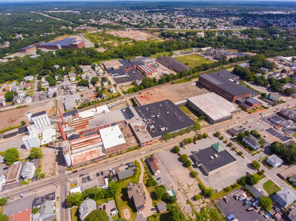 Historic mill factory aerial view on Broad Street with Blackstone River at the background in city center of Central Falls, Rhode Island RI, USA.