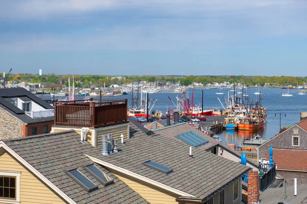 New Bedford harbor aerial view with fishing boats docked at piers near historic downtown of New Bedford, Massachusetts MA, USA.