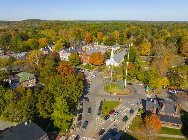 Concord Monument Square aerial view including Holy Family Parish Church and Concord Town Hall in fall with foliage in town center of Concord, Massachusetts MA, USA.